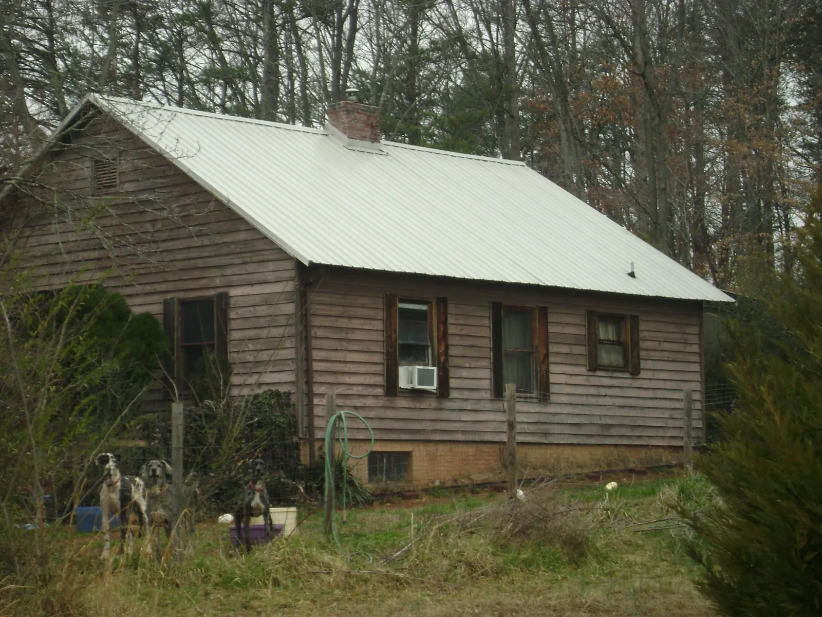 White metal roof on an old wood sided farmhouse, from a Metal Roof Installation job in Fernley